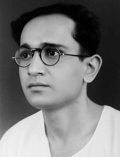 Studio portrait of a young Batukeshwar Dutt wearing round spectacles.